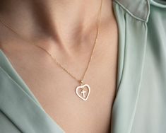 Sacred Heart Cross 14K Necklace, Gold Heart Pendant with Cross Charm,    Heart & Cross Chain,Love Gift, Valentine's Day Gift. 14K Real Gold  Pendant and 14K Gold Chain NOT dipped and NOT painted. Heart Cross 14K Necklace is stunning and better than you imagined! It is very nice pendant for Valentines Day 💝 ❤️ 💕  Express your love with our Gold Heart Pendant with Cross Charm - a captivating symbol of  an love meticulously designed for the modern romantic soul. 💖    Adorned with heart and cross charm, this an elegant and modern piece that is ideal for any woman who wishes to express their love or as a gift for someone special in your life.This pendant is a declaration of love.   With dainty heart pendant with  dangle cross motif ,this necklace will be your favorite in your jewelry collect Heart And Cross Necklace, Valentine's Day Gift Cross Pendant Jewelry, Gold Heart-shaped Metal Necklace, Symbolic Gold Heart-shaped Necklaces, Gold Heart-shaped Chain Necklace For Valentine's Day, Heart Pendent, Cross Heart, Cross Chain, Heart Pendant Gold