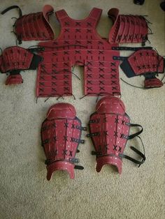 four red catchers gear laid out on the floor