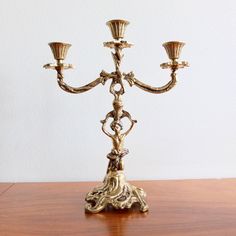 a golden candelabra on a wooden table