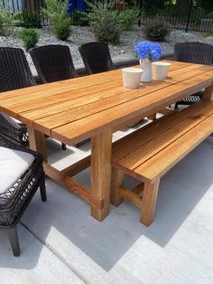 a wooden table sitting on top of a patio