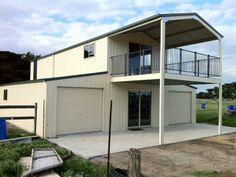 a two story house with garage and attached deck