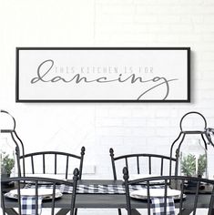 this kitchen is for dancing sign above the dining room table with chairs and checkered table cloth