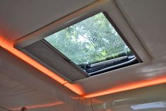 the inside of a bus with a bright orange light