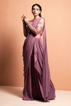 Mauve draped saree gown with floral hand embellished with 3D Silk yarn, crystals, pearls, glass beads and kasab thread work.
Component: 1
Embellished
Neckline: Round
Sleeve Length: Full
Fabric: Crepe
Color: Purple

Sheer back
Closure: Back zip - Aza Fashions Mauve Saree, Mauve Fabric, Embellished Saree, Bengali Culture, Saree With Belt, Asian Clothing, Draped Saree, Bridesmaid Attire, Desi Wear