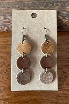 "Genuine leather earrings upcycled from post consumer waste - giving it a new life and keeping it out of the landfill! Very lightweight hook earrings.  These earrings measure 2.25\" in drop from top of ear wire. Features bronze colored accent and earring post.  *ORDERING INFO* This listing is for one pair of leather earrings.  Each pair of earrings comes on an earring card with rubber back.  All orders come beautifully packaged in a re-usable muslin bag, perfect for gifting! Our genuine leather have a natural back, and some of our leathers it can be a bit fuzzy. Natural leather may have slight variations due to natural product. Pairs are very closely matched, however your earrings may not be identical to the earrings pictured. We want to make sure you are happy with your purchase.  If you Leather Loop Earrings, Leather Scrap Jewelry, Diy Leather Earrings Tutorials, Leather Earring Designs, Diy Earrings Packaging, Leather And Bead Earrings, Leather Earrings Ideas, Circuit Earrings, Leather Earrings Cricut