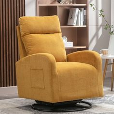 a yellow recliner chair sitting on top of a white rug in front of a book shelf