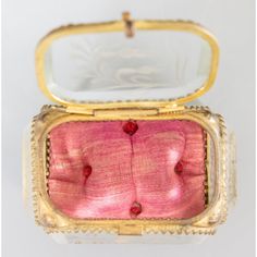 an antique pink and gold ring box