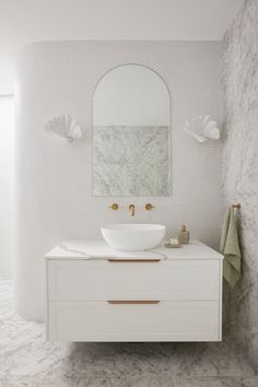 a bathroom with a sink and mirror in it