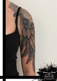 a woman's arm with tattoos on it and an image of a bird in the background