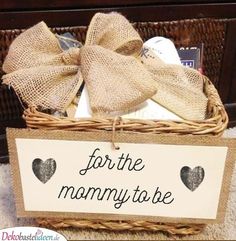 a basket with a sign that says for the mommy to be and two hearts on it