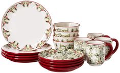 a set of red and white dishes with holly designs