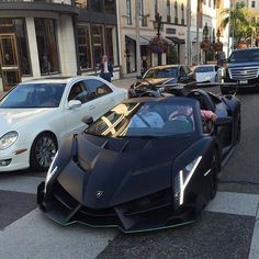 a black sports car is parked on the street