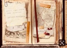 an open book with old maps and writing on the pages, including a red pen