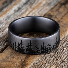 A striking forest-inspired motif rings the circumference of this handsome men's wedding band. Fashioned in tantalum, the inside of the ring is lined with smooth black tantalum to complete the look. The band features Comfort-Fit, which gives a narrower feel than it's actual width when worn. Comfort-Fit rings are designed to have a slightly rounded inside surface so less of the metal touches your finger, which enhances the feel of the ring while wearing and sliding it on and off your finger. Western Wedding Rings, Nature Wedding Ring, Antler Wedding Band, Groom Ring, Promise Rings For Guys, Black Wedding Band, Titanium Wedding Band, Jared The Galleria Of Jewelry, Line Pattern