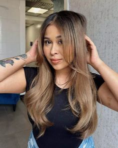 Step into a world where ash and honey tones meet in a chic 'bronde' balayage, ideal for all seasons. With long, flowing layers that dance with every step and a subtle side part, this style boasts a sleek, voluminous blowout. Intrigued? Click to see more in our gallery and join us on Pinterest for endless inspiration! ** Photo Credit: Instagram @coloredbycarlos Blowout Hair