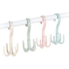 four hooks are hanging on the side of a white rail with pink, blue and green handles