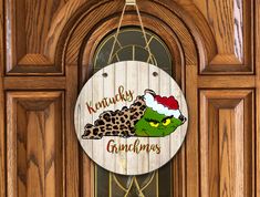 a wooden sign hanging on the front door of a house that says kentucky gumkins