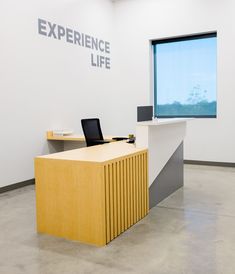 an office with a desk and laptop on it