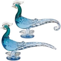 two blue glass birds sitting on top of each other