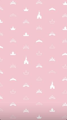 a pink background with white crowns and clouds in the sky on top of each other