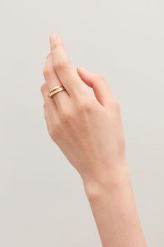 a woman's hand with a gold ring on it