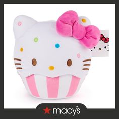 a hello kitty stuffed animal with a pink bow on it's head and polka dots