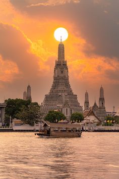 the sun is setting in front of an ornate building