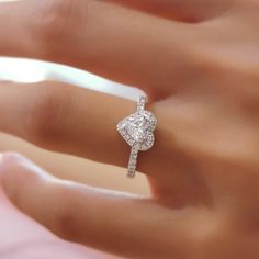 a woman's hand with a diamond ring on it