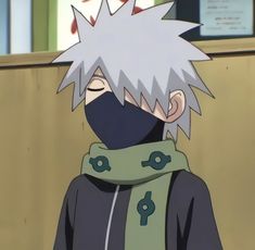 a man with white hair wearing a black hoodie and green scarf around his neck