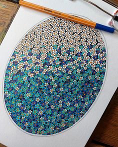 an art work with blue and white dots in the shape of a circle on paper