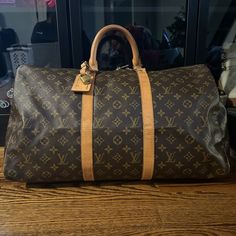 Great Used Condition Louis Vuitton Keepall 45 With Luggage Tag, And Large Lv Dust Bag. Clean Inside, All Corners In Great Shape, No Scratching Or Rubbing. Bottom Has Small Stain On Leather Strap, I Have Not Attempted To Remove It. Lock Does Not Come With The Bag- It’s On From My Speedy For Decoration! No Scratches Or Cracks On Lv Monogram. Louis Vuitton Keepall 45, Keepall 45, Louis Vuitton Keepall, Lv Monogram, Luggage Tag, Luggage Tags, Travel Bags, Louis Vuitton Bag, Leather Straps