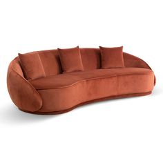 an orange couch with pillows on the back and arms, sitting in front of a white background