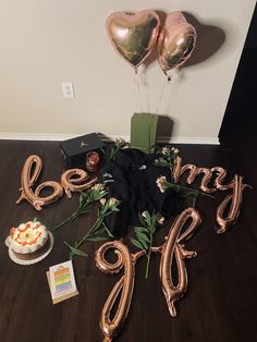 some balloons that are on top of a wooden table with the words happy 90th