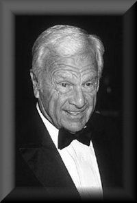 an older man wearing a tuxedo and bow tie