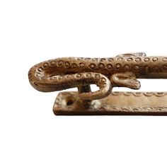 an old metal object with chains attached to it's sides on a white background