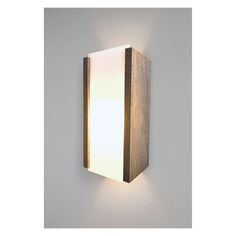 a wall mounted light that is on the side of a wall with a wooden frame