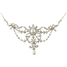 An Edwardian diamond and pearl necklace, of a natural round half pearl, measuring approximately 8.3 mm of diameter, to the centre of an old brilliant-cut diamond-set cluster all to an old brilliant-cut diamond-set scroll and bow openwork designed frame with natural pear shaped pearl drop, measuring approximately 7.7 x 6.7 mm, Gem&Pearl laboratory certificate, the diamonds estimated a total of 5 1/2 carats, on chain, circa 1910, gross weight 22.54 grams. An alluring early twentieth century piece. Diamond And Pearl Necklace, Edwardian Necklace, Art Deco Pendant Necklace, Ruby And Diamond Necklace, Diamond Drop Necklace, Natural Pearl Necklace, Pearl And Diamond Necklace, Edwardian Jewelry, White Pearl Necklace