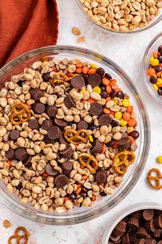 three bowls filled with cereal and pretzels on top of a white countertop