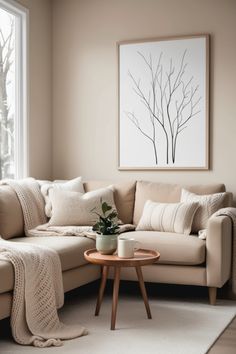 a living room with a couch, coffee table and large window in it's corner