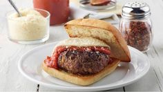 a plate with a sandwich on it next to some condiments and salt shakers