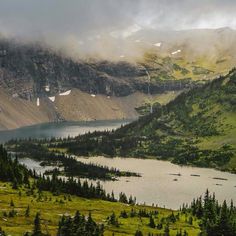 the mountains are covered in fog and clouds