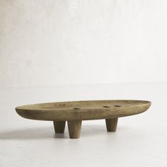 a wooden surfboard sitting on top of a white table