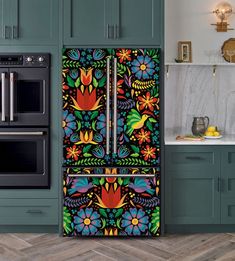 the refrigerator is decorated with colorful flowers and birds on it's front, next to an oven