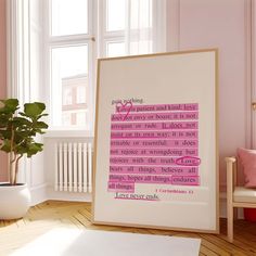 a room with pink walls and a white framed art print on the wall next to a potted plant