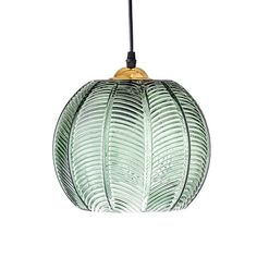 a green glass pendant light hanging from a black cord on an isolated white wall background