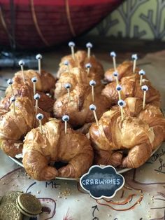 croissants are arranged on a plate with pins