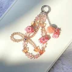 a key chain with beads and flowers on it