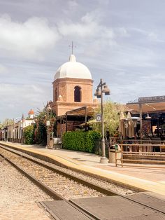 a train track with a building in the background