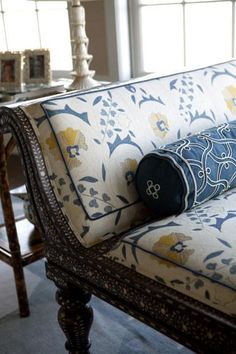 a blue and white couch sitting in front of a window