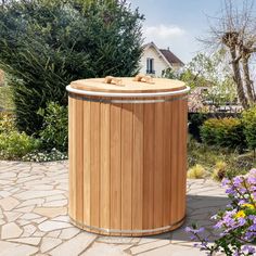 a large wooden tub sitting on top of a stone walkway